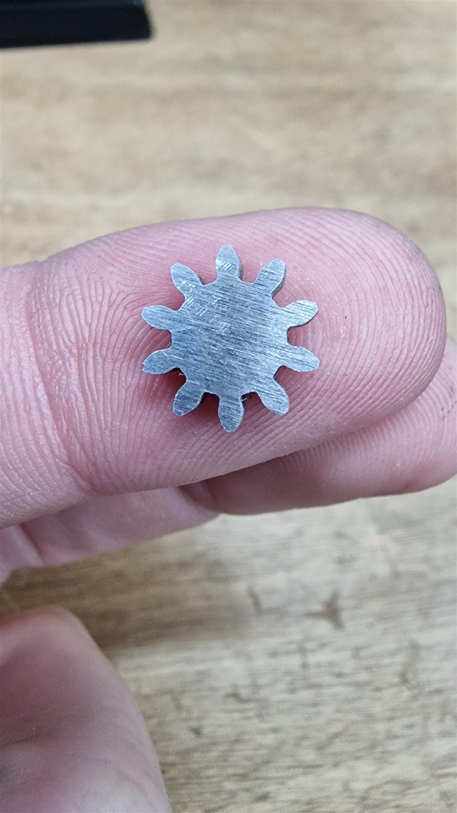 Small gear resting on a fingertip